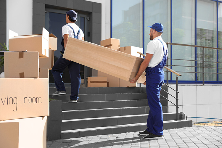 Movers Carrying Heavy And Bulky Furniture