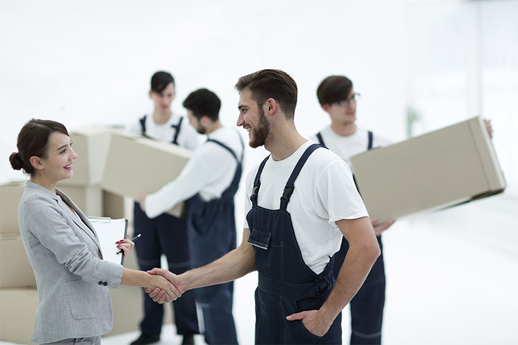 A Satisfied Female Customer Is Shaking Hands With Movers